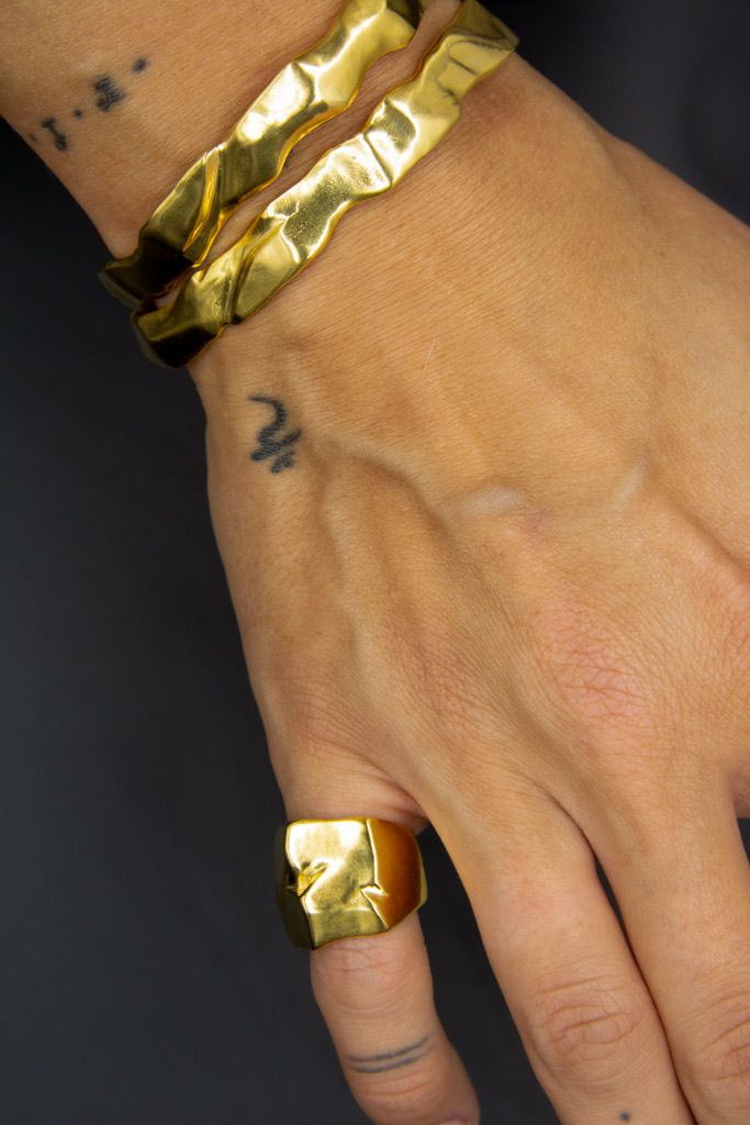 Gold Ourea cuff bracelet with a textured sculptural surface inspired by mountains and volcanic landscapes. 